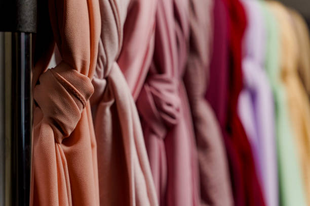 istock Silk scarf muslim. Multi-colored plain scarves on hanger. 1324426336