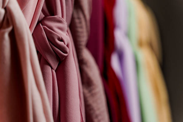 istock Silk scarf muslim close-up. Multi-colored plain scarves on hanger. 1324426379