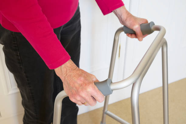 istock Old person with walking frame inside house 1324426590