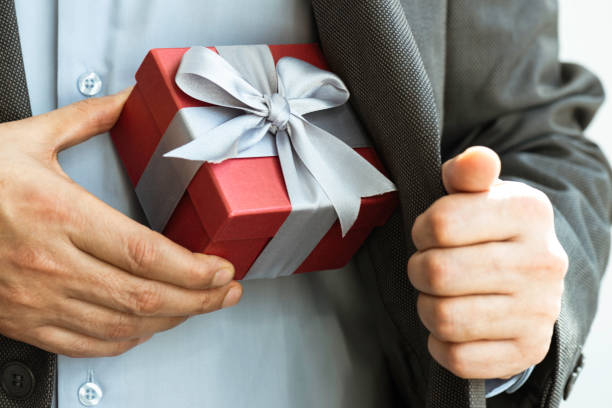 istock Businessman giving Gift Box 1324428694