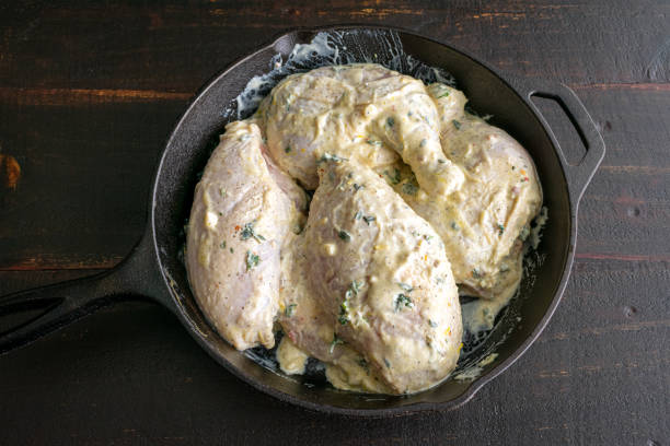 istock Marinated Chicken Quarters in a Cast-Iron Skillet 1324432601