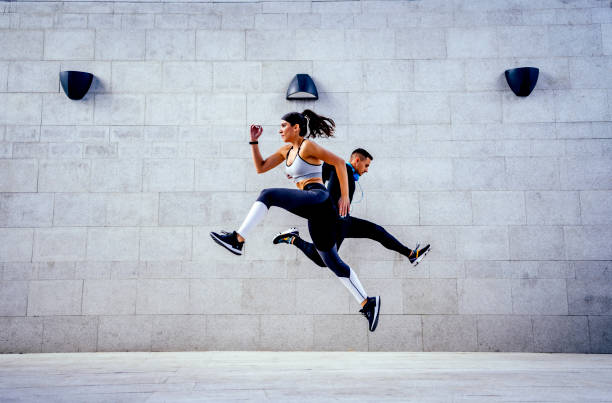 istock Sporty woman and man jumping 1324437552