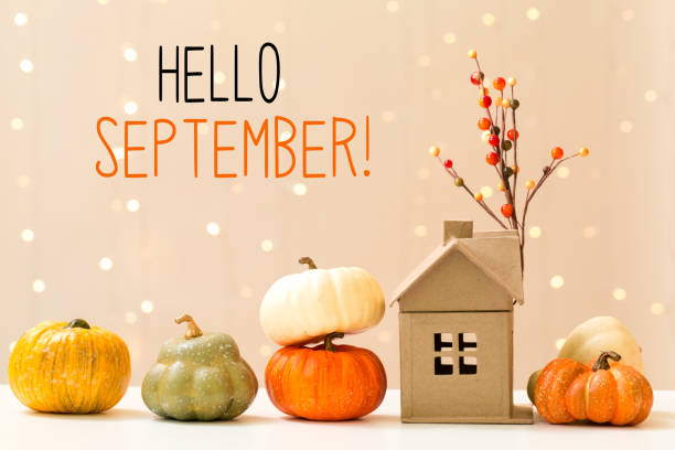 istock Hello September message with pumpkins with a house 1324440159