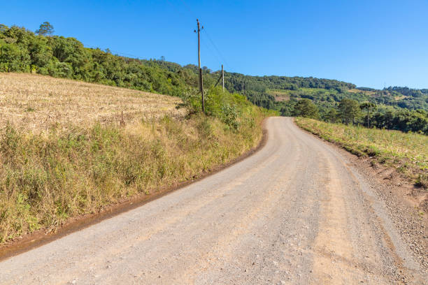 istock Dirty road with farms around 1324441692