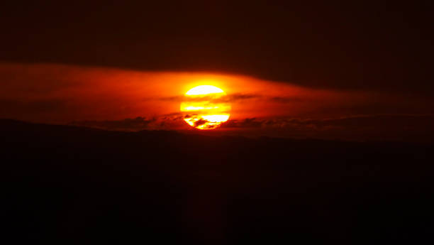 istock Beautiful sunset in front of black silhouette from clouds 1324444915