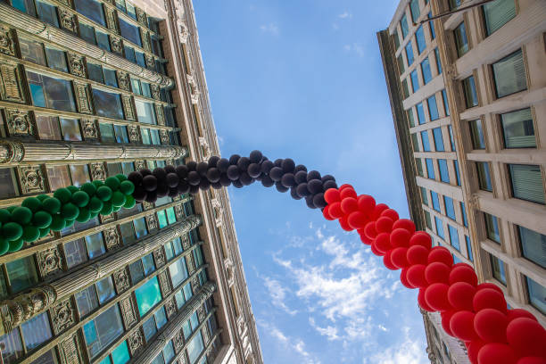 Red-Black-Green flag from balloons on a blue sky background. Black Liberation African American Flag. Pan-African flag.  Juneteenth National Independence Day. Copy space for your text parade photos stock pictures, royalty-free photos & images