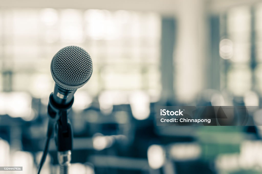 Microphone voice speaker in business seminar, speech presentation, town hall meeting, lecture hall or conference room in corporate or community event for host or townhall public hearing Town Hall Meeting Stock Photo