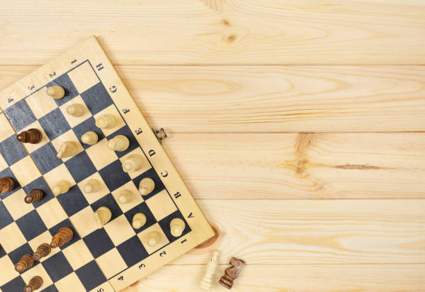 istock Chess board and chess figures on wooden table. Popular logic game for logical thinking. 1324459151