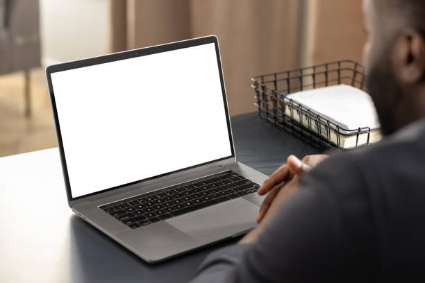 istock African American businessman looking at blank laptop computer screen, studying at home concept distance education, online meeting, video call 1324459730