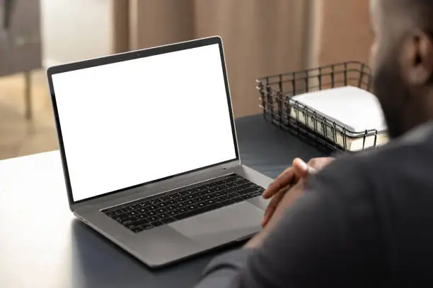 African American businessman looking at blank laptop computer screen, studying at home concept distance education, online meeting, video call