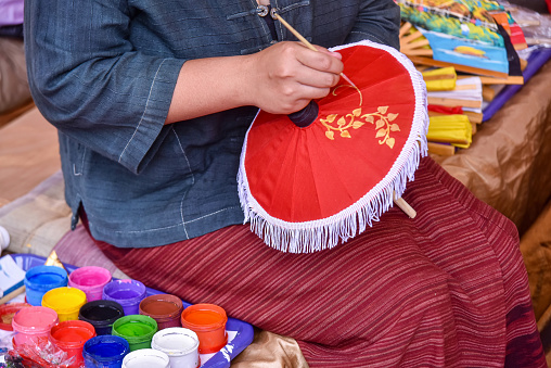 Painting on Handmade umbrella of the village Bo Sang, Chiang mai, Thailand. It a famous handicraft and souvenir of Chiang mai.