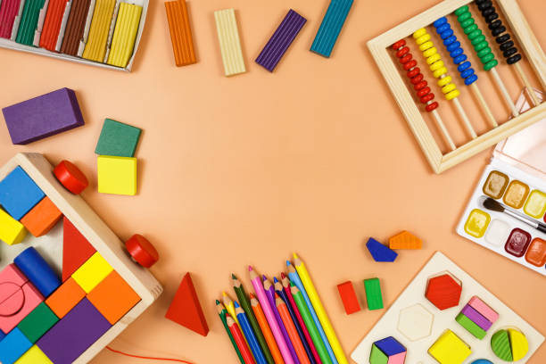 istock Colorful cubes, paints, pencils, blocks, modeling clay on orange background. Interesting math, games for preschool for kids. Education, back to school concept 1324460728