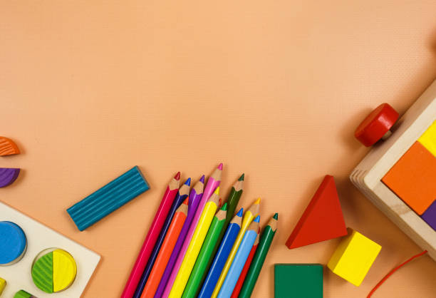istock Colorful cubes, paints, pencils, blocks, modeling clay on orange background. Interesting math, games for preschool for kids. Education, back to school concept 1324460738
