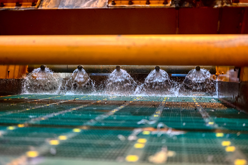 Vibrating screen, ore washing with liquid. The liquid is poured out in a fan-like stream from special nozzles.