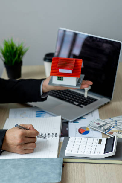 istock House model with real estate agent 1324464867