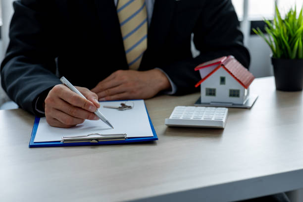 istock House model with real estate agent 1324464877