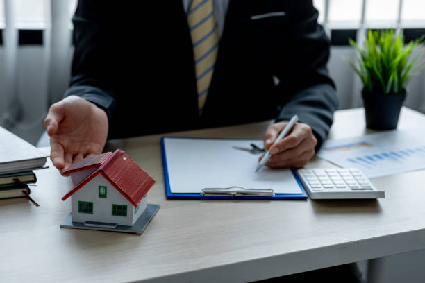 istock House model with real estate agent 1324464886