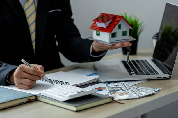 istock House model with real estate agent 1324464895