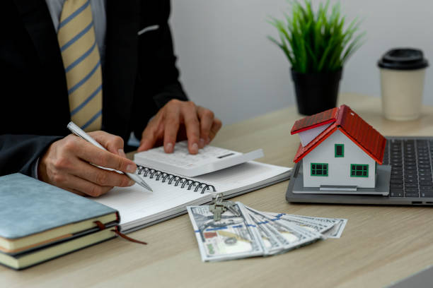 istock House model with real estate agent 1324464919
