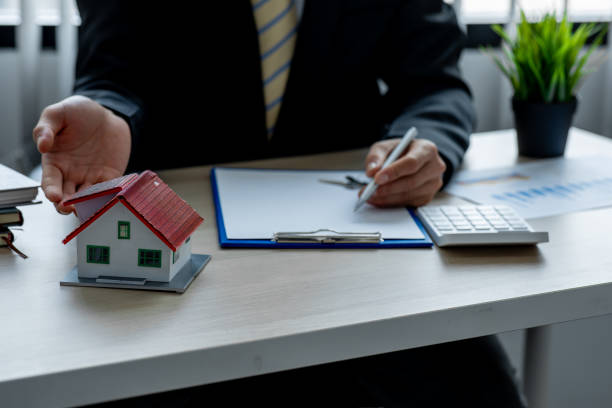 istock House model with real estate agent 1324464974