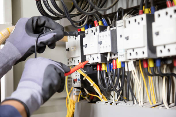 istock Electrician engineer tests electrical installations and wires on relay protection system. Adjustment of scheme of automation and control of electrical equipment. 1324465740