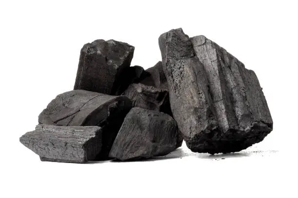 Photo of Natural wood charcoal, traditional charcoal or non smoke and odorless charcoal hard wood charcoal isolated on white background.