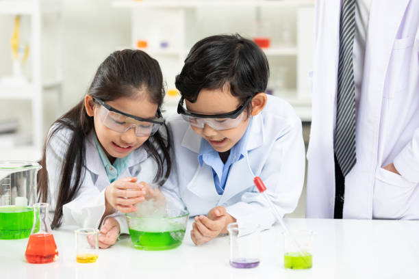 istock child students doing or testing a chemical experiment with science teacher by them side in laboratory classroom 1324466492