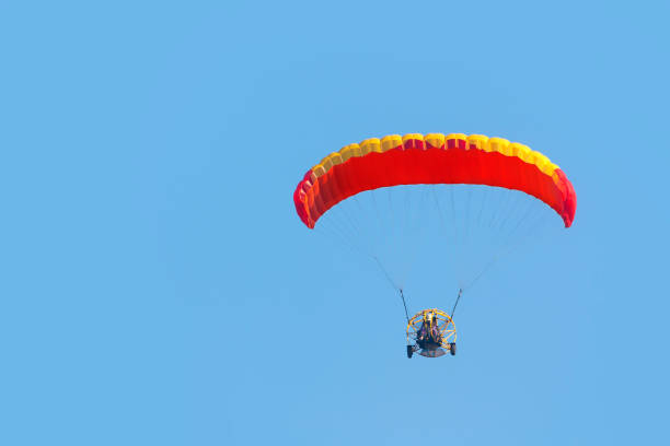 istock A paraglider with a motor on a sky background 1324466595