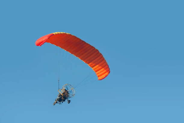 istock A paraglider with a motor on a sky background 1324466599