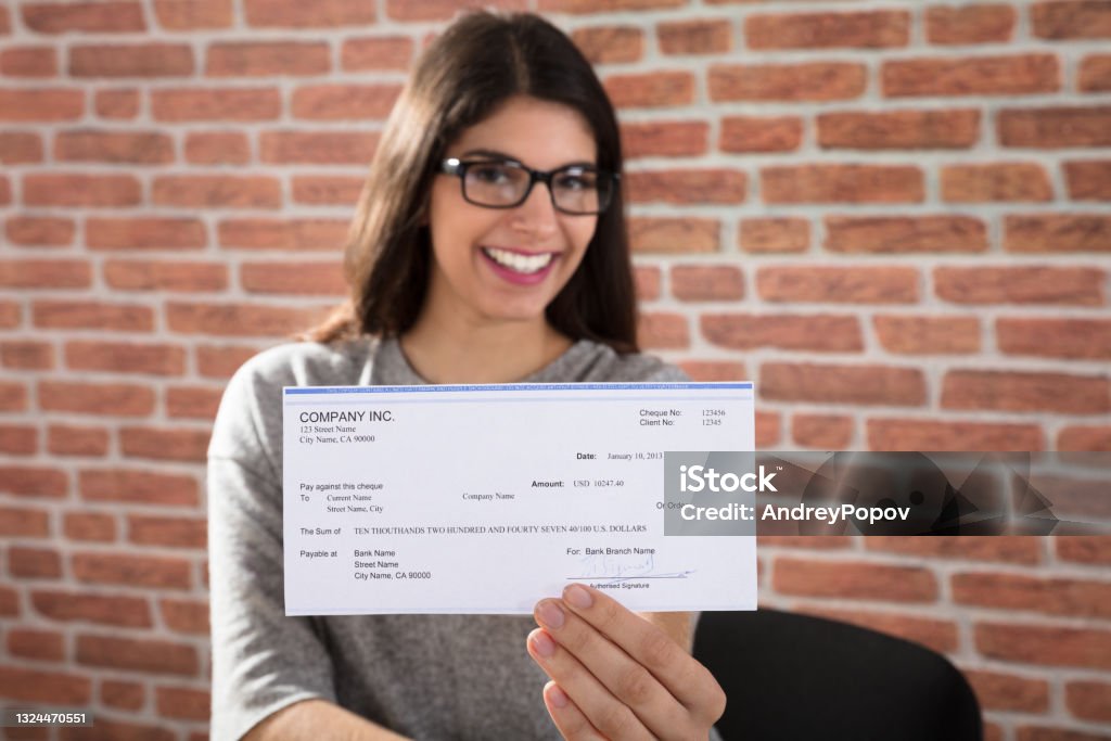 Woman Showing Company Cheque Close-up Of A Smiling Woman Showing Company Cheque Paycheck Stock Photo