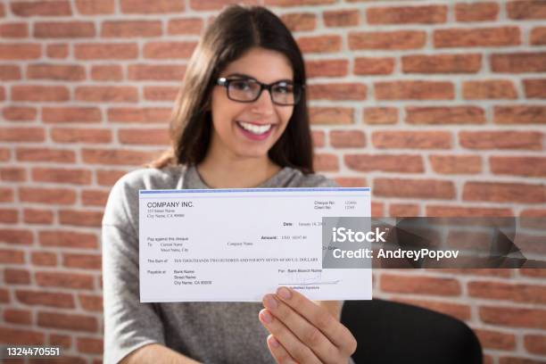 Woman Showing Company Cheque Stock Photo - Download Image Now - Paycheck, Check - Financial Item, Holding