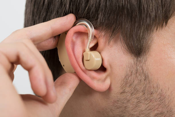 istock Man Wearing Hearing Aid In Ear 1324471843
