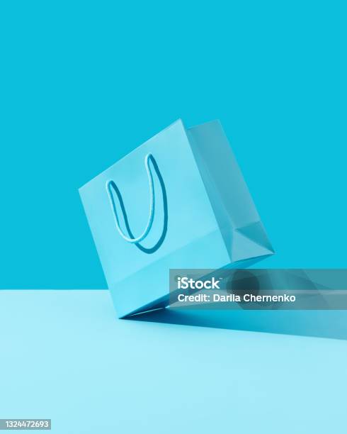 Paper Shopping Bag On Blue Background Shopping Sale Delivery Concept Stock Photo - Download Image Now