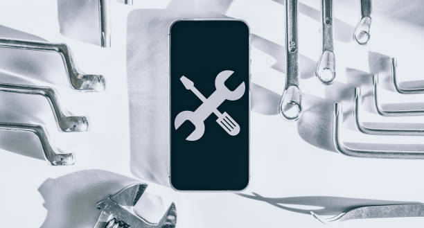 Mobile repair service. Technician workplace with phone and special repairing tools. Electronics repair service, device production concept.