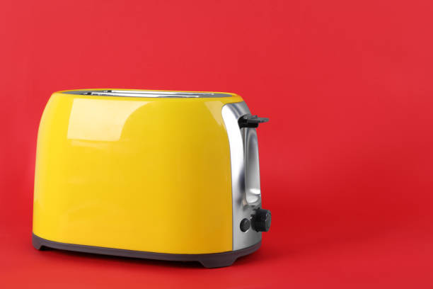 istock Modern toaster on red background, space for text. Household equipment 1324478719