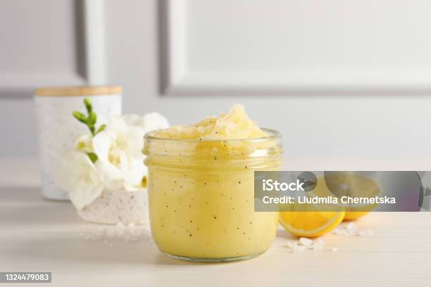 Body Scrub In Glass Jar Freesia Flowers And Lemon On Wooden Table Stock Photo - Download Image Now