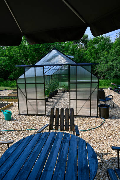 istock greenhouse table and chairs with sunshade in garden 1324480062