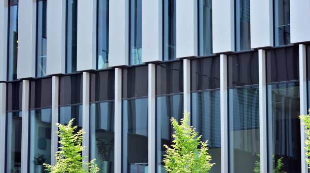 istock Eco architecture. Green tree and glass office building. 1324480890