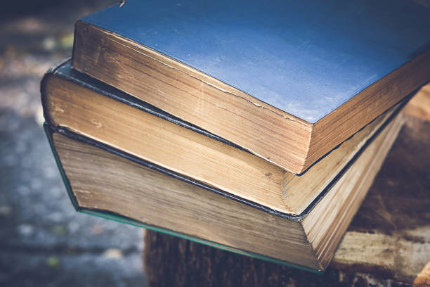 ancient books on a wooden table , literacy and knowledge concept - book law instruction manual old imagens e fotografias de stock