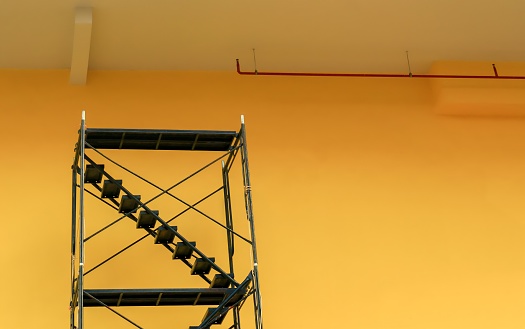 Background of Metal Scaffolding Against Yellow Building
