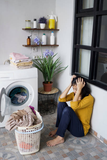 istock asian housewife doing some laundry at home feeling angry 1324486144