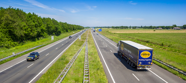 Panorama of a truck and cars on highway A28 through the landscape of Drenthe, Netherlands