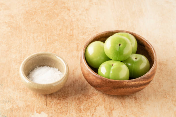 istock fresh green plum fruits in a bowl on table 1324495872