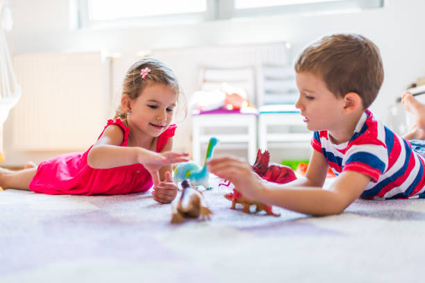 istock Children playing with toy dinosaurs 1324496066