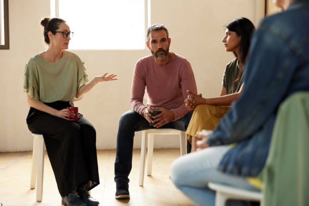 istock Mental health professional facilitates support at group therapy. 1324496642