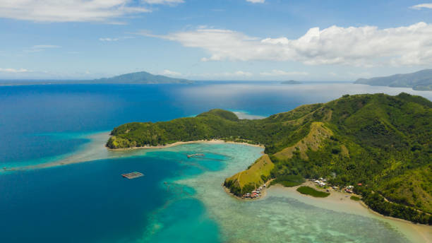 Tropical islands and blue sea. Philippines, Mindanao Famous Tourist Site: Sleeping Dinosaur Island located on the island of Mindanao, Philippines. Aerial view of tropical islands and blue sea. davao city stock pictures, royalty-free photos & images