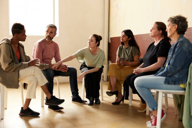 istock A member of group therapy gives support to another member. 1324496716