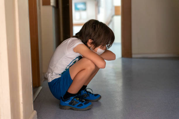 istock boy waiting sadly in hospital corridor 1324498015