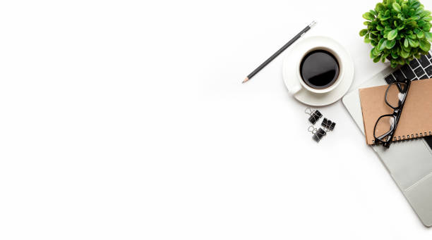 istock Flat lay, top view office table desk. Workspace with blank Laptop, office supplies, pencil, green leaf, and coffee cup on white background. 1324498971