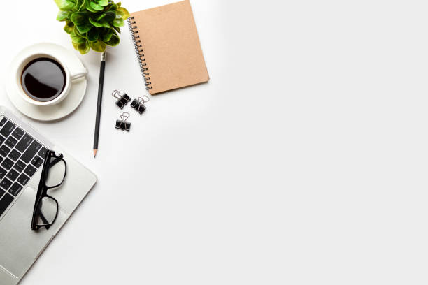 istock Flat lay, top view office table desk. Workspace with blank Laptop, office supplies, pencil, green leaf, and coffee cup on white background. 1324498972